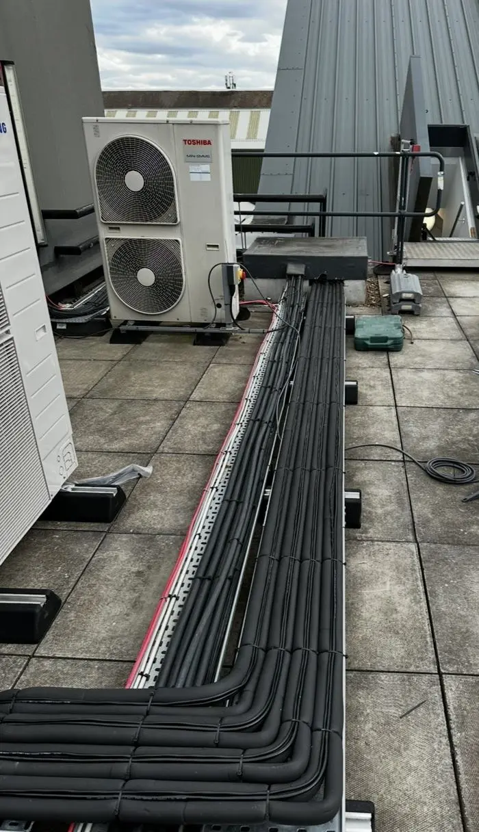 Toshiba outdoor unit with insulated pipework on a roof